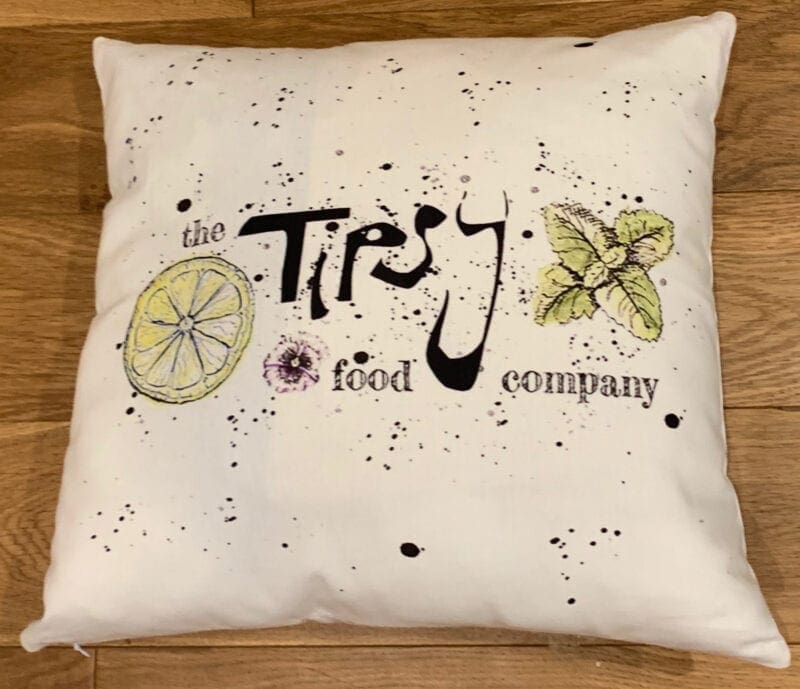 A pillow with the words'tiry the food company'on it.
